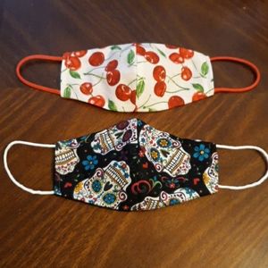 2 cute facemasks one has wire on nose